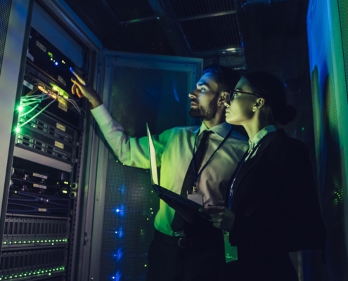 Two IT professionals working in data center
